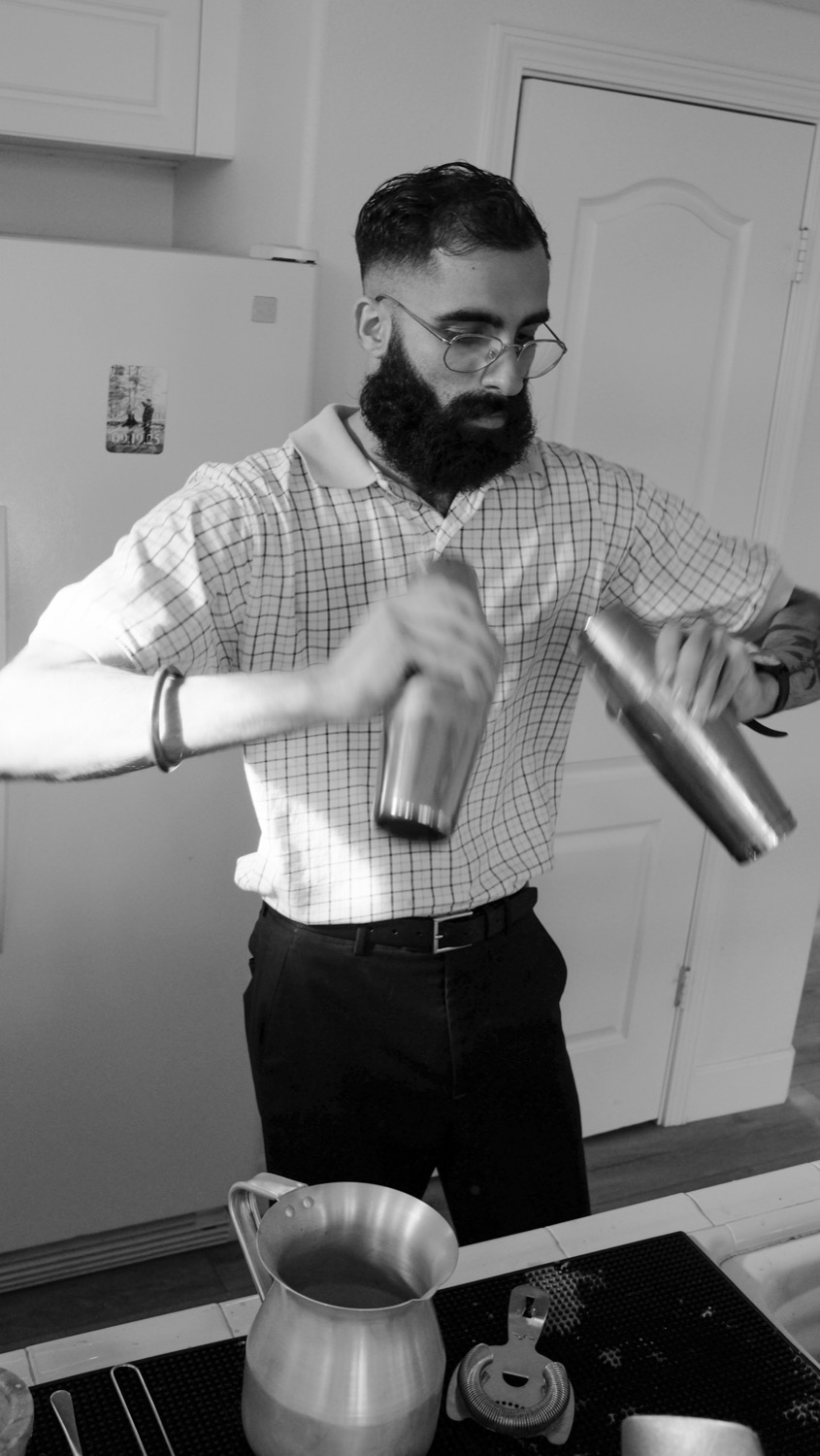 Chai pulled between two steel tumblers, in black and white