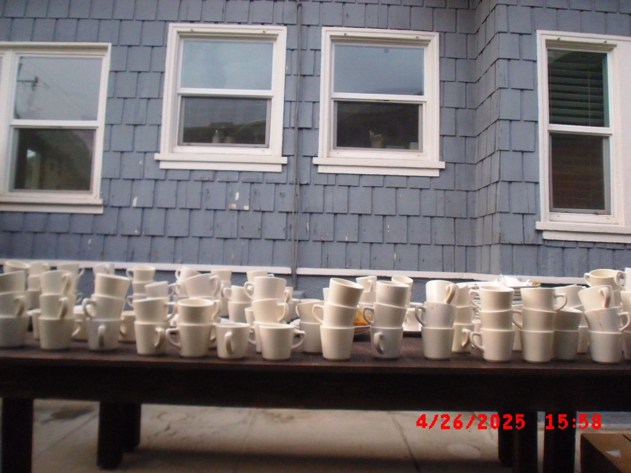 Chai cups gathered along a long table outside a house at a Hatti pop-up